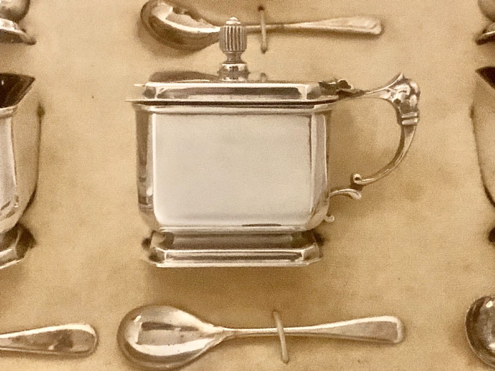 A six-piece Art Deco silver condiment set with matching spoons presented inside a fitted blue presentation box. View VI