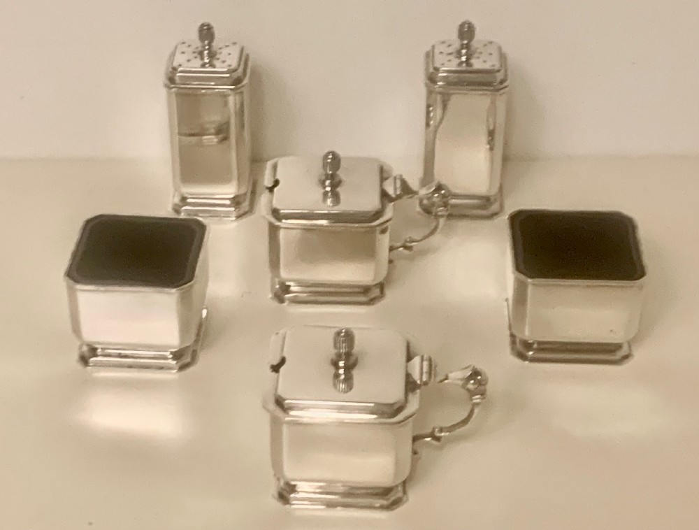 A six-piece Art Deco silver condiment set with matching spoons presented inside a fitted blue presentation box. View VIII