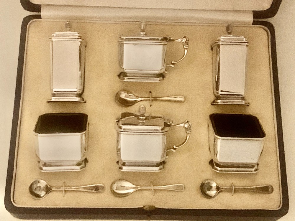 A six-piece Art Deco silver condiment set with matching spoons presented inside a fitted blue presentation box. View XIII