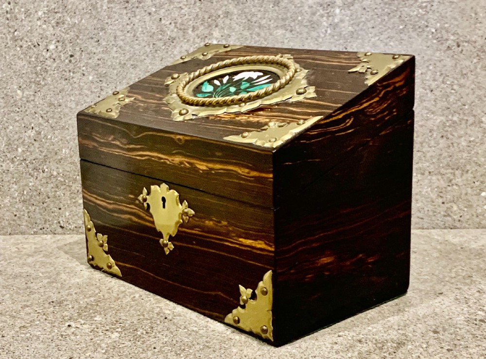 A dark striped coromandel wood stationery box with brass corner mounts, a central oval pietra dura floral plaque, and a brass keyhole escutcheon. View III