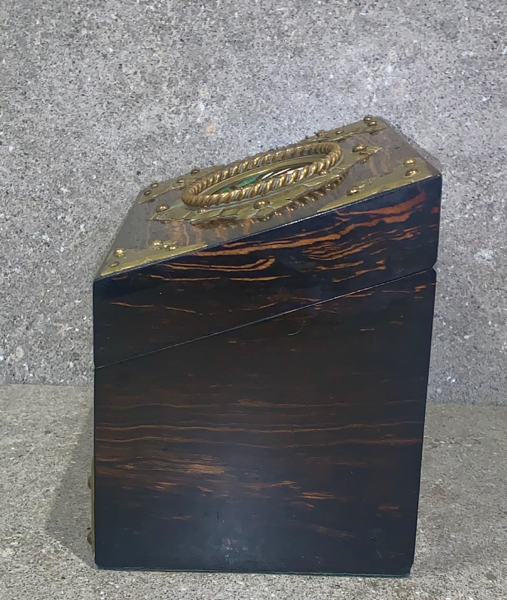 A dark striped coromandel wood stationery box with brass corner mounts, a central oval pietra dura floral plaque, and a brass keyhole escutcheon. View IV