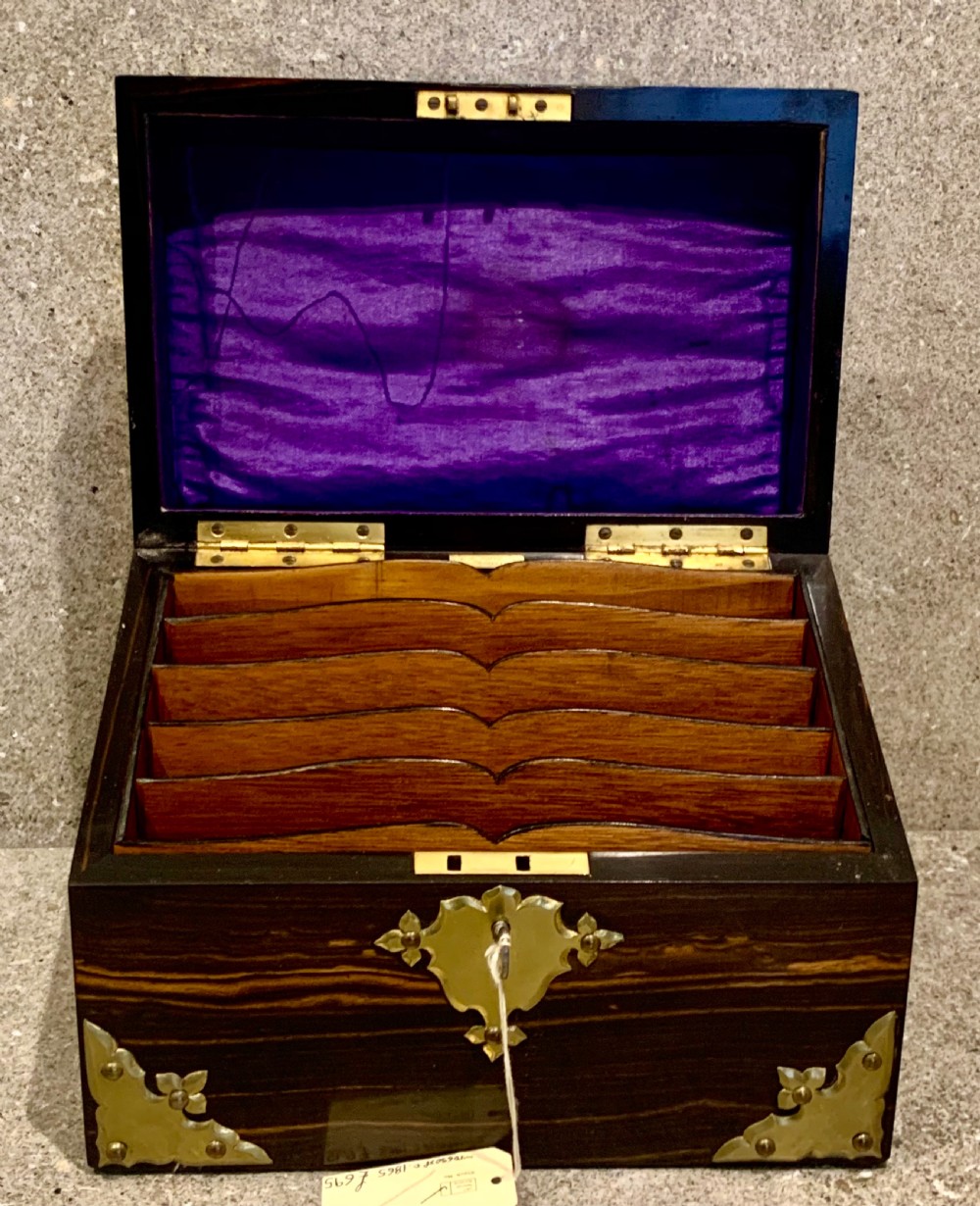 A dark striped coromandel wood stationery box with brass corner mounts, a central oval pietra dura floral plaque, and a brass keyhole escutcheon. View VIII