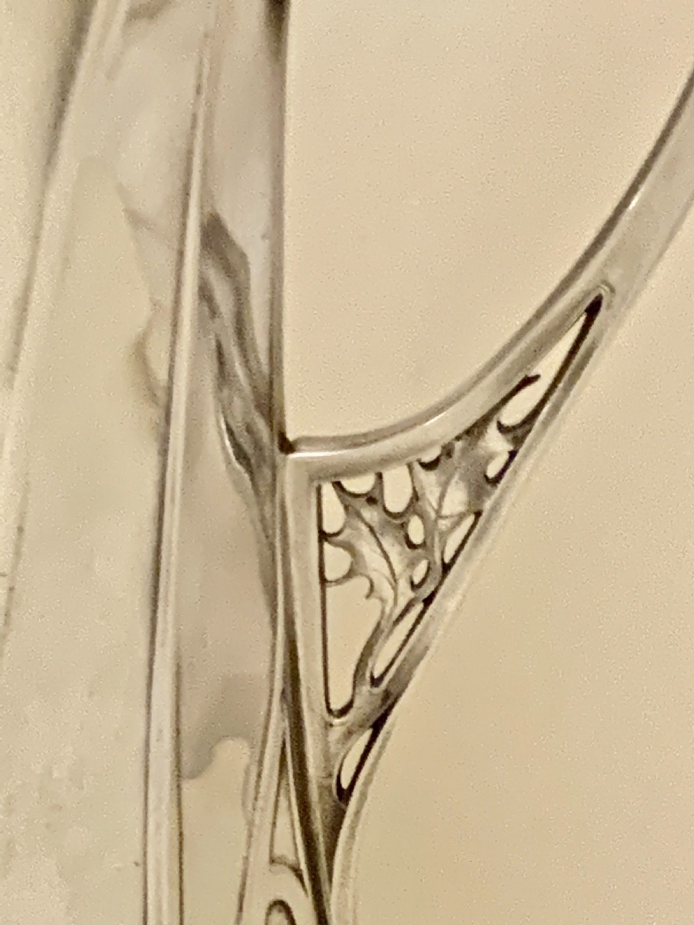 An Art Nouveau silvered pewter liqueur set comprising a tall spouted decanter with organic handles and six matching small tapered cups. View XX