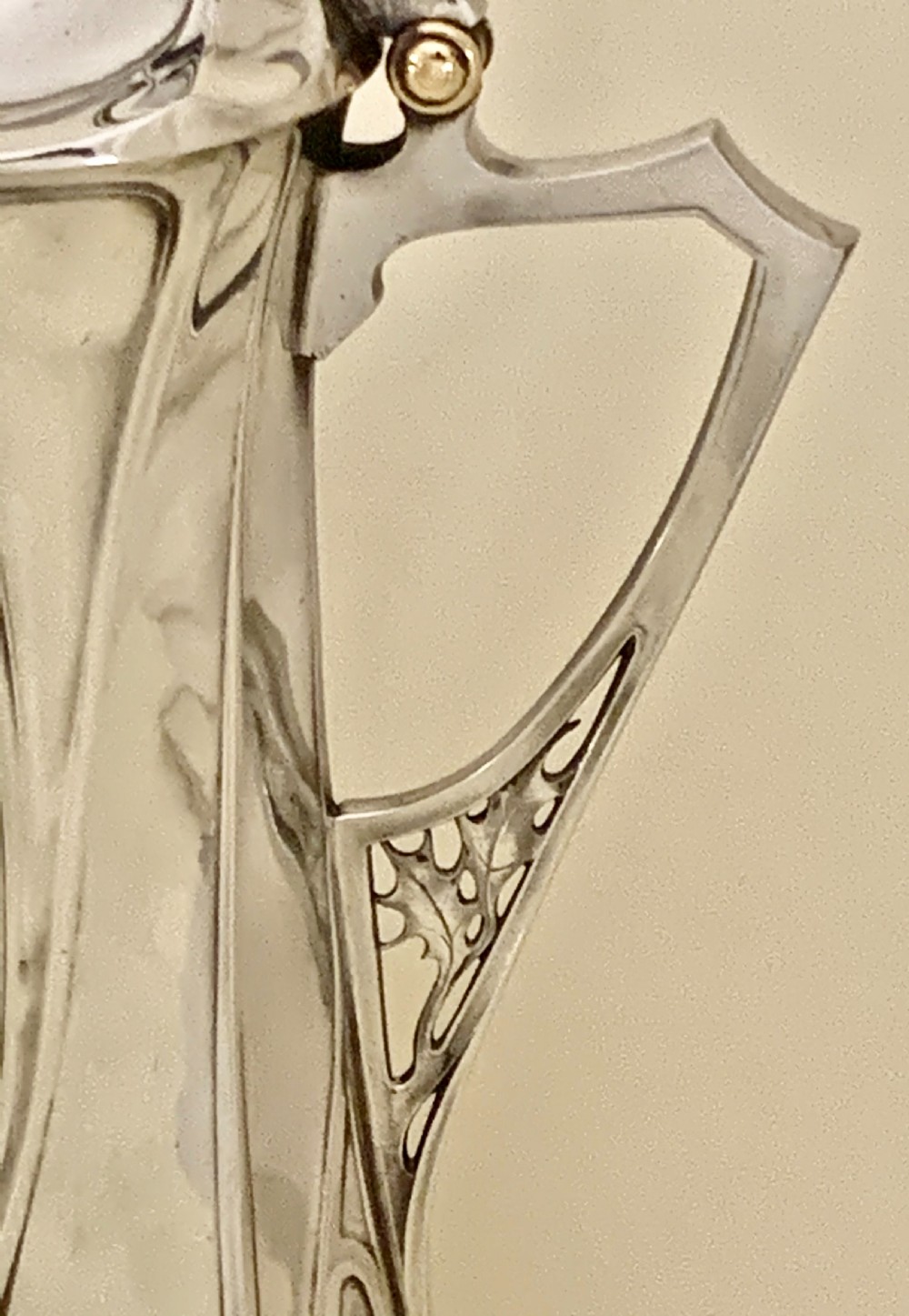 An Art Nouveau silvered pewter liqueur set comprising a tall spouted decanter with organic handles and six matching small tapered cups. View XXI