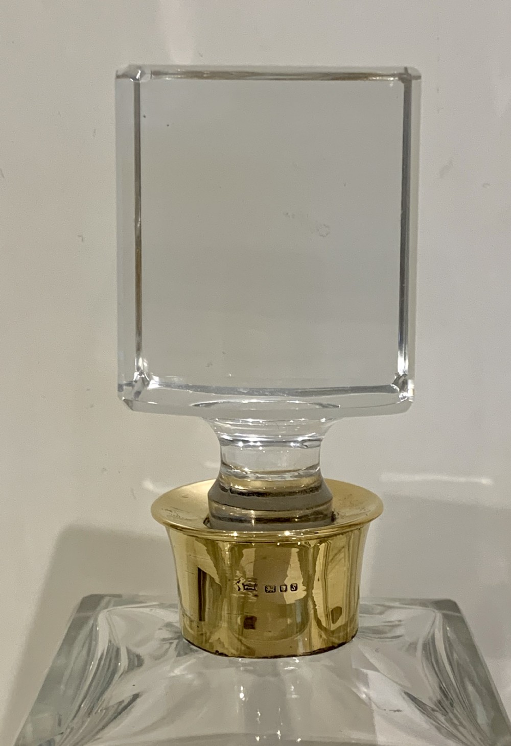 A pair of rectangular clear glass spirit decanters featuring gold-toned silver collars around the necks and matching square glass stoppers. View III