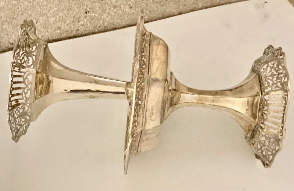 An Edwardian sterling silver two-tiered centrepiece with pierced decorative borders, a flared pedestal column, and a shaped hexagonal base. View VII