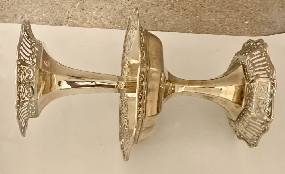 An Edwardian sterling silver two-tiered centrepiece with pierced decorative borders, a flared pedestal column, and a shaped hexagonal base. View VIII
