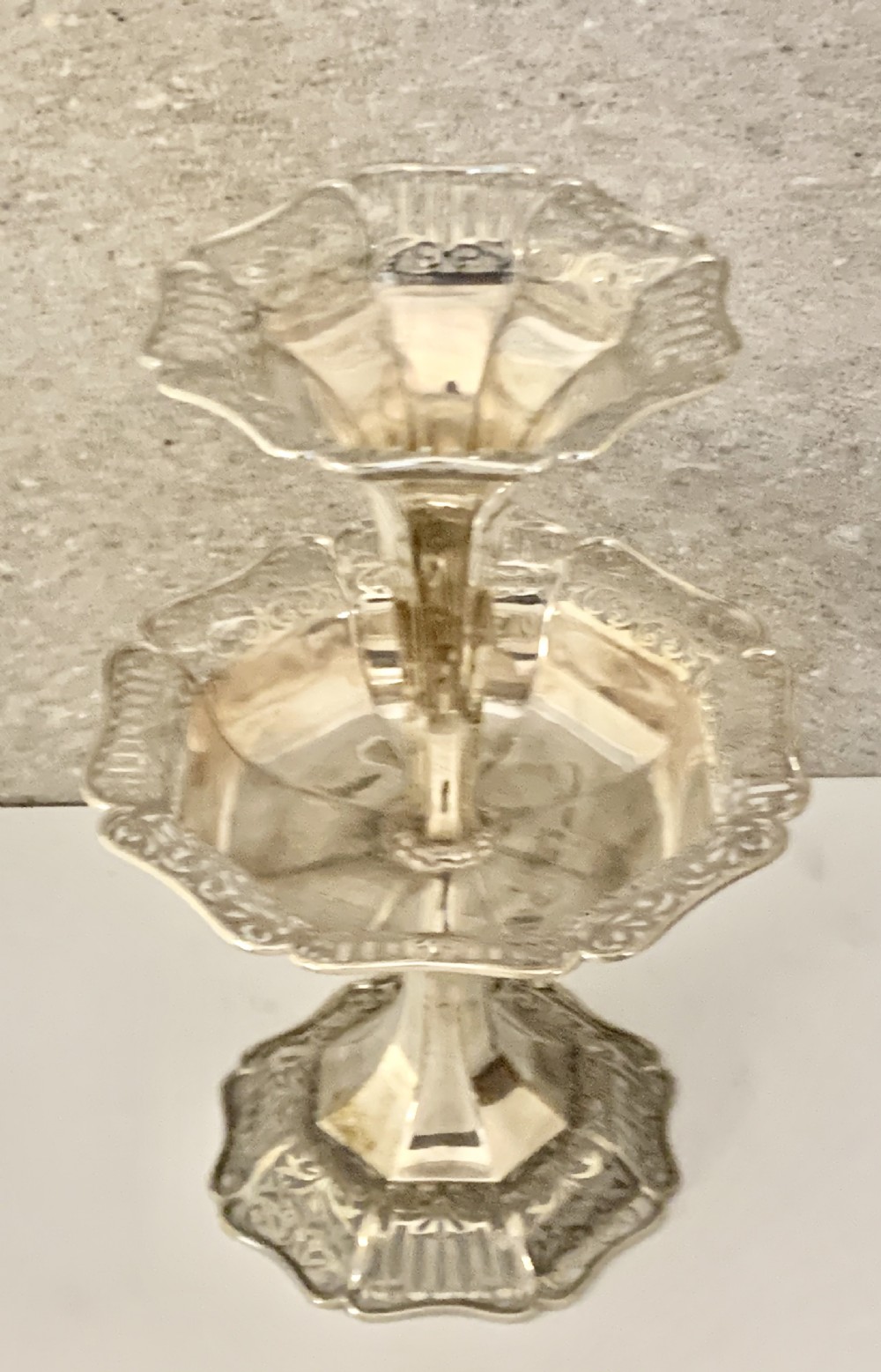 An Edwardian sterling silver two-tiered centrepiece with pierced decorative borders, a flared pedestal column, and a shaped hexagonal base. View XI