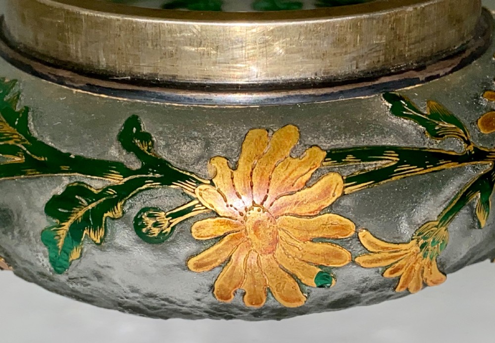 An Art Nouveau green cameo glass bowl featuring etched yellow floral enamelling and a chased silver cover. View V