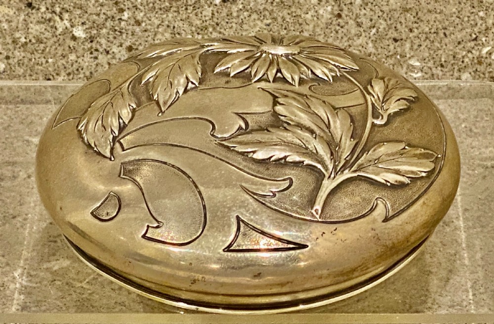 An Art Nouveau green cameo glass bowl featuring etched yellow floral enamelling and a chased silver cover. View X