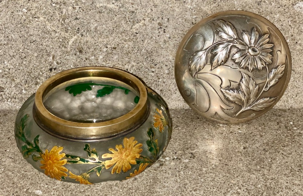 An Art Nouveau green cameo glass bowl featuring etched yellow floral enamelling and a chased silver cover. View XV
