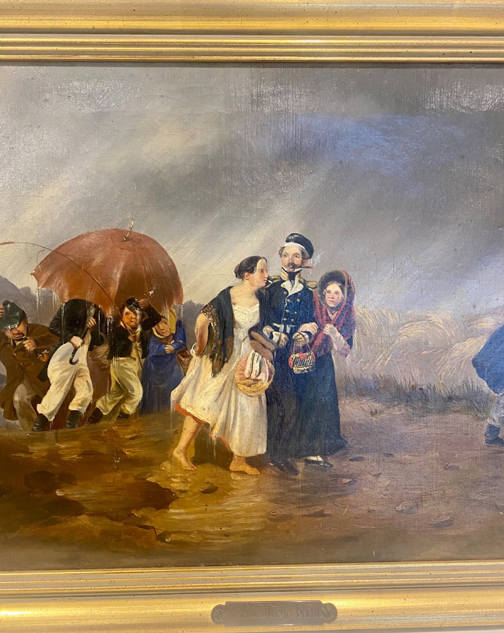 A 19th-century oil painting depicting several figures walking through rain under an umbrella, housed in a moulded gold frame. View IV
