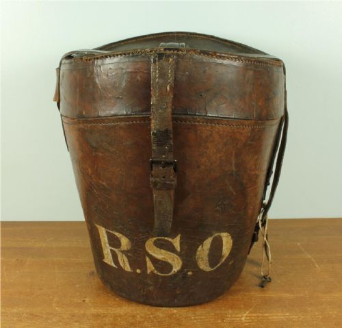 fig 1. A dark brown antique leather double hat box featuring a top carrying strap, buckled securing straps, and hand-stitched details.