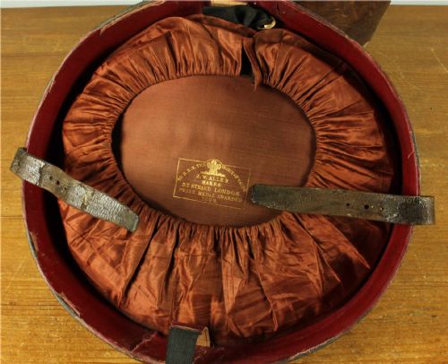 fig 3. A dark brown antique leather double hat box featuring a top carrying strap, buckled securing straps, and hand-stitched details.
