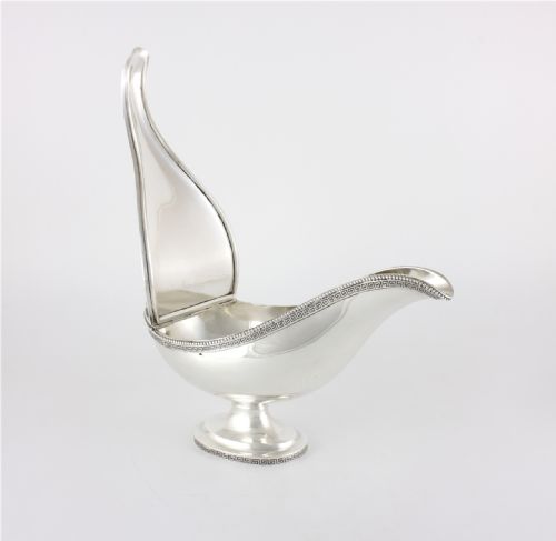 fig 1. A nineteenth-century sterling silver lidded sauce boat featuring a Greek key border, beaded rim, double-scroll handle, and a pedestal foot.