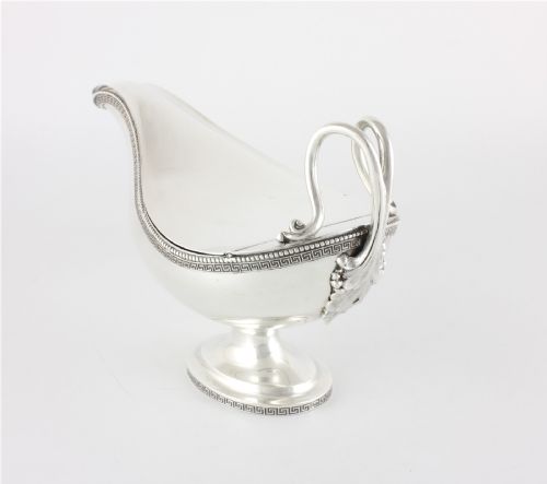 fig 3. A nineteenth-century sterling silver lidded sauce boat featuring a Greek key border, beaded rim, double-scroll handle, and a pedestal foot.