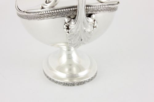 fig 4. A nineteenth-century sterling silver lidded sauce boat featuring a Greek key border, beaded rim, double-scroll handle, and a pedestal foot.