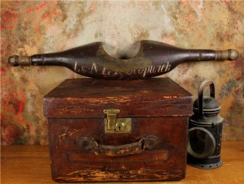 fig 2. A carved dark wood railway shoulder yoke with original hand-painted lettering showing station and company markings.