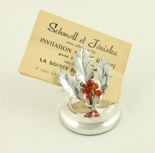 fig 3. An Edwardian sterling silver menu holder designed as holly leaves with red agate berries set upon a circular stepped base.