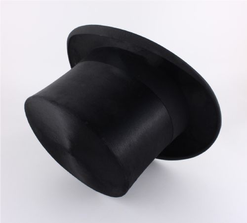 fig 1. A black silk plush top hat with a grosgrain ribbon band resting on top of an oval hat box.