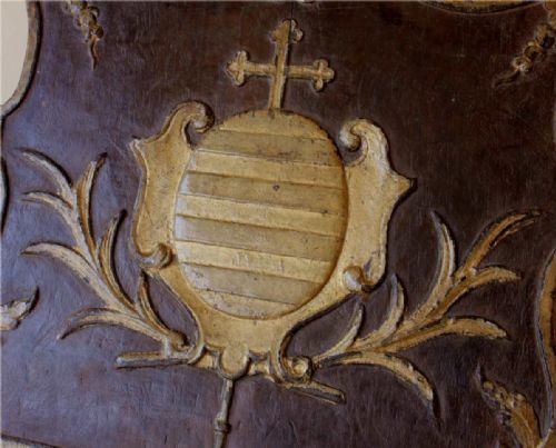 fig 2. An 18th-century carved wooden folding missal stand featuring a dark finish with gilded heraldic motifs and scalloped edges.