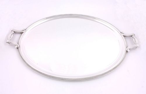fig 2. An extra large oval silver-plated tray with reeded border detail and two outer scroll handles on a plain background.
