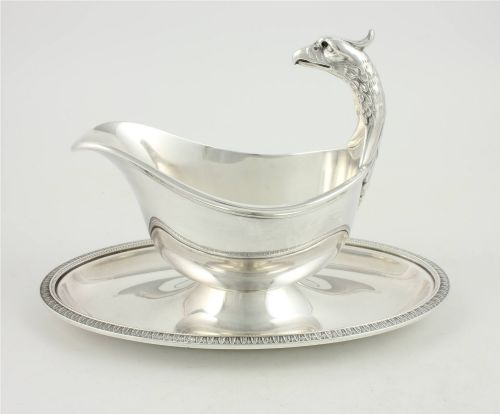 fig 1. A silver-plated sauce boat featuring a sculpted eagle head handle set upon an integrated oval underplate.