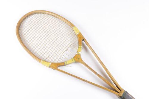 fig 1. A 1930s Hazells Streamline wooden tennis racket with a triple shaft throat shown alongside a square wooden racket press.