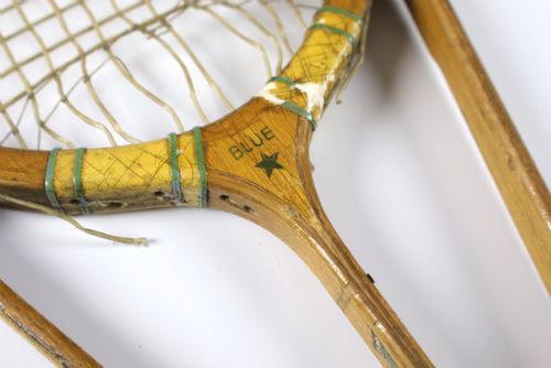fig 3. A 1930s Hazells Streamline wooden tennis racket with a triple shaft throat shown alongside a square wooden racket press.