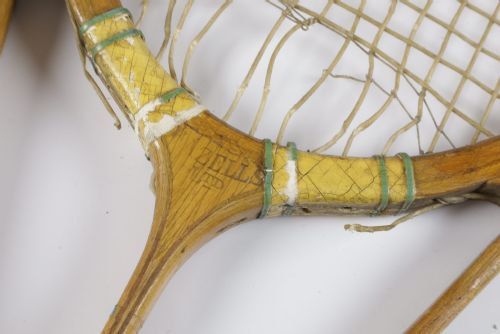 fig 4. A 1930s Hazells Streamline wooden tennis racket with a triple shaft throat shown alongside a square wooden racket press.