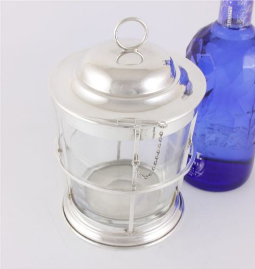 fig 1. A silver-plated and clear glass ice bucket designed in the form of a nautical ships lantern with a removable lid and chain detail.