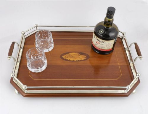 fig 1. An octagonal brown wooden serving tray featuring a shell marquetry inlay and a polished silver-plated gallery rail.