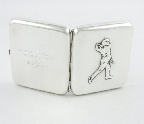 fig 3. An Edwardian sterling silver cigarette case featuring an embossed relief figure of a golfer in mid-swing on the front cover.