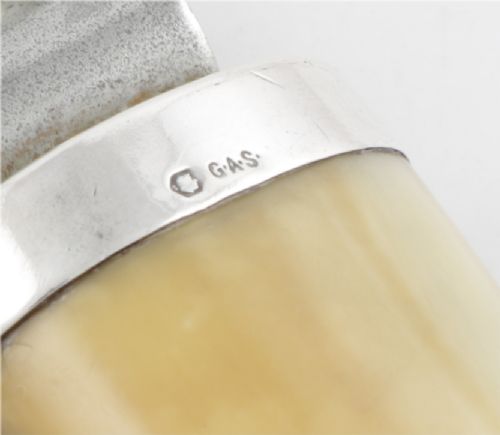 An antique cigar cutter crafted from a curved cream-coloured boar tusk fitted with a cast silver eagle head terminal and a silver cutting mechanism at the opposing end. View IX