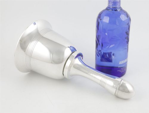 fig 2. A silver plated novelty cocktail shaker in the shape of a handbell with a smooth turned handle and incised line detailing.