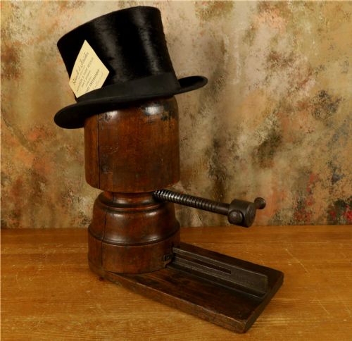 fig 1. An antique French milliners hat stretcher crafted from dark polished wood with a split head block and an adjustable iron turn-screw mechanism set on a flat timber base.