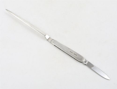 fig 2. A vintage hallmarked sterling silver letter opener featuring an engine-turned handle casing with an integrated folding knife blade.