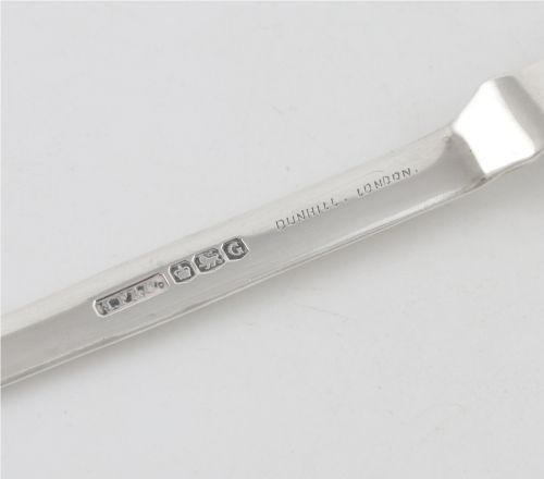 fig 4. A vintage hallmarked sterling silver letter opener featuring an engine-turned handle casing with an integrated folding knife blade.