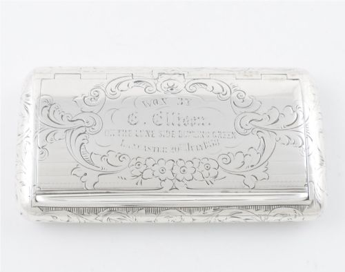 fig 1. An engraved Victorian sterling silver rectangular snuff box featuring intricate foliate scrollwork and inscribed presentation text.