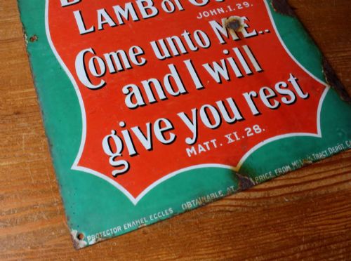 fig 3. A rectangular vitreous enamel sign with a green background and a red central cartouche displaying white and black printed scripture texts.