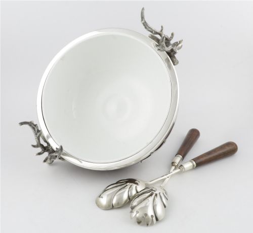 fig 1. A turned dark oak bowl featuring a silver-plated rim, cast stag head handles, a central vacant silver shield, and matching serving utensils.