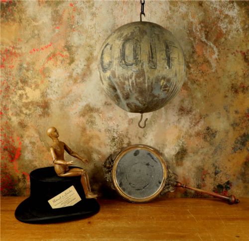 fig 1. A 19th-century spherical zinc French coiffeur trade sign featuring hand-painted lettering and iron hanging hooks.