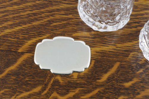 fig 2. A late Victorian shaped English oak serving tray featuring a silver-plated raised gallery rail, twin wood-mounted handles, and a central blank silver cartouche.