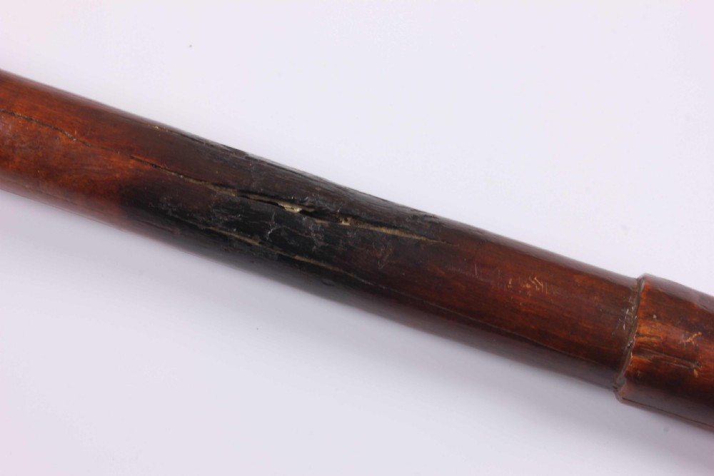 A carved wooden Kanak bird head war club with a smooth tapered shaft and a beak-shaped terminal, crafted from dark brown hardwood. View XXI
