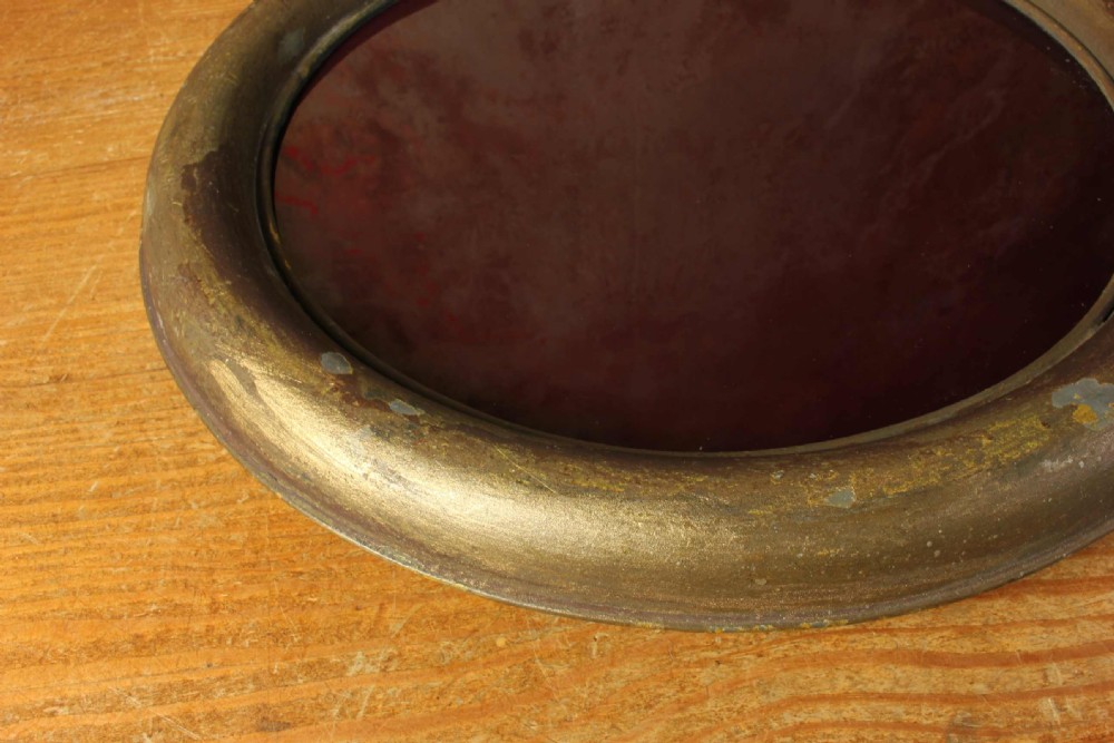 An antique brass optician trade sign in the form of oversized pince-nez spectacles, featuring one red glass lens and one dark blue glass lens. View XVI
