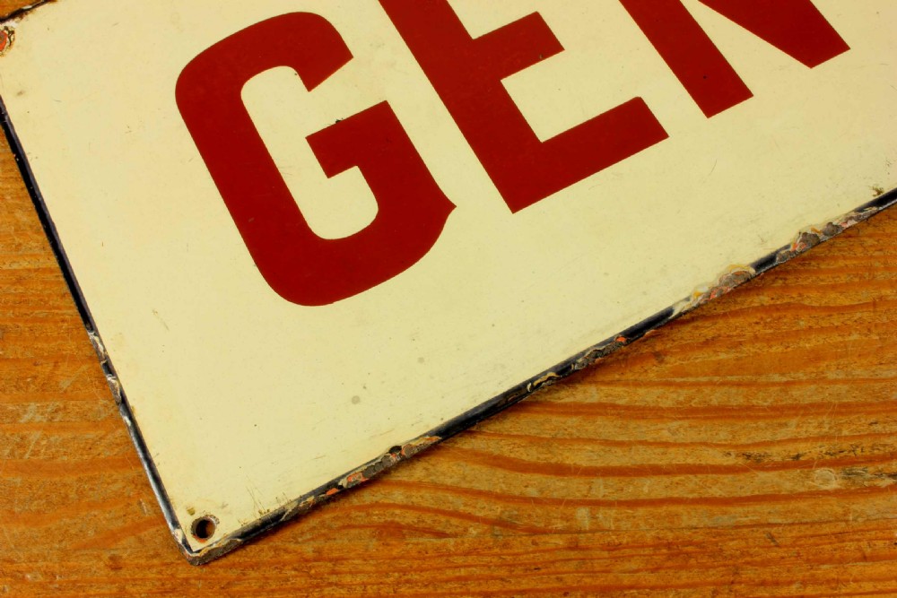 An antique rectangular off-white vitreous enamel sign displaying bold burgundy typography reading GENTLEMEN with patinated edges. View XVII
