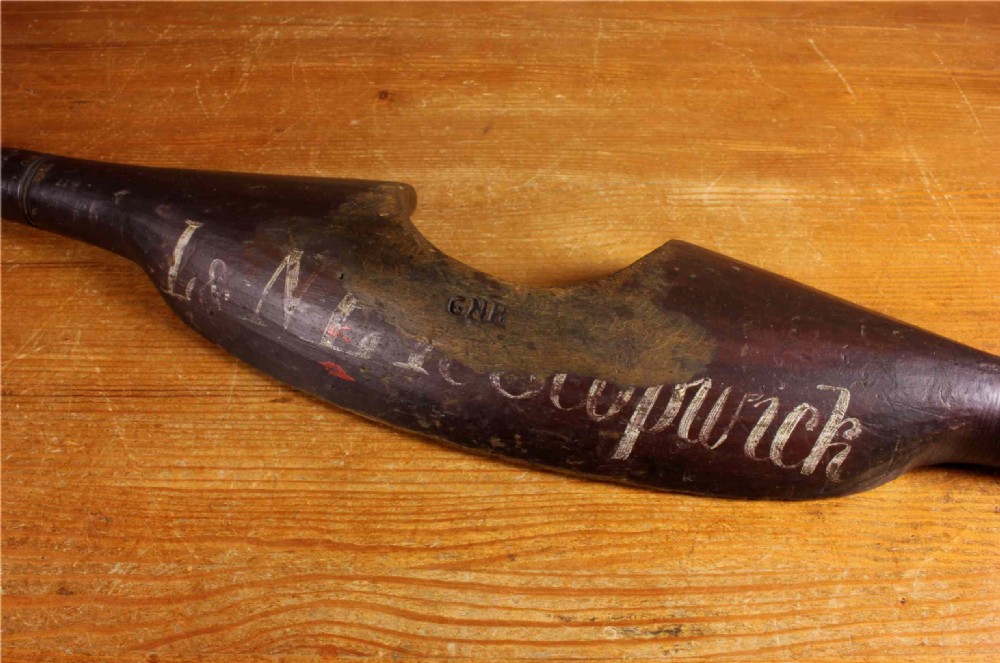 A carved dark wood railway shoulder yoke with original hand-painted lettering showing station and company markings. View XVI