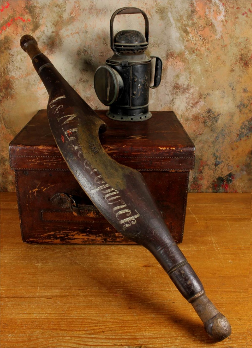 A carved dark wood railway shoulder yoke with original hand-painted lettering showing station and company markings.