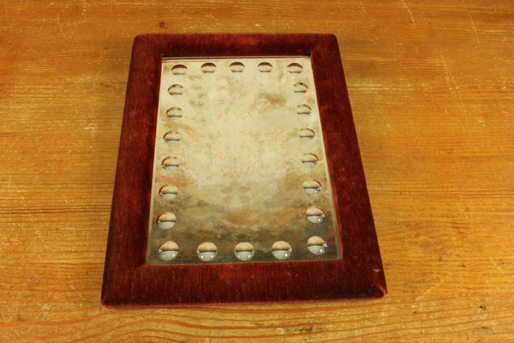 A rectangular Victorian wall mirror featuring a red velvet frame and a perimeter of circular convex lenses cut into the glass. View IV