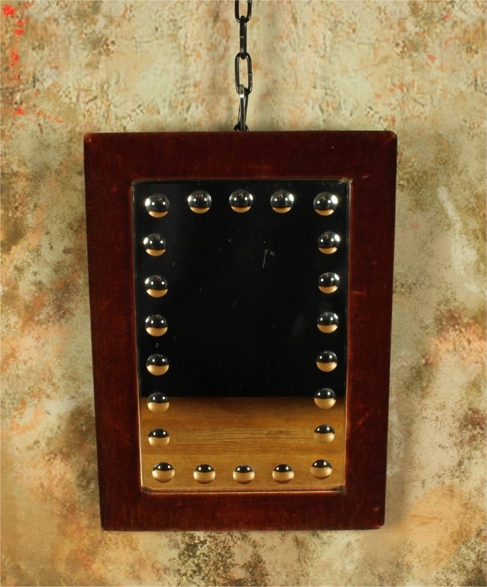 A rectangular Victorian wall mirror featuring a red velvet frame and a perimeter of circular convex lenses cut into the glass. View X
